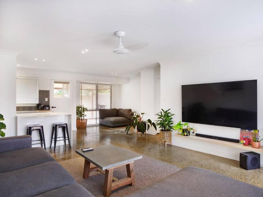 a living room with a large flat screen tv at Benowa 1 Bedroom renovated townhouse in Gold Coast