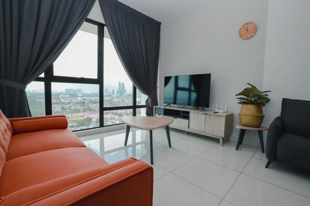 a living room with a couch and a television at Southkey 2BR, 5-6 PAX, WIFI, Mid Valley JB, in Johor Bahru
