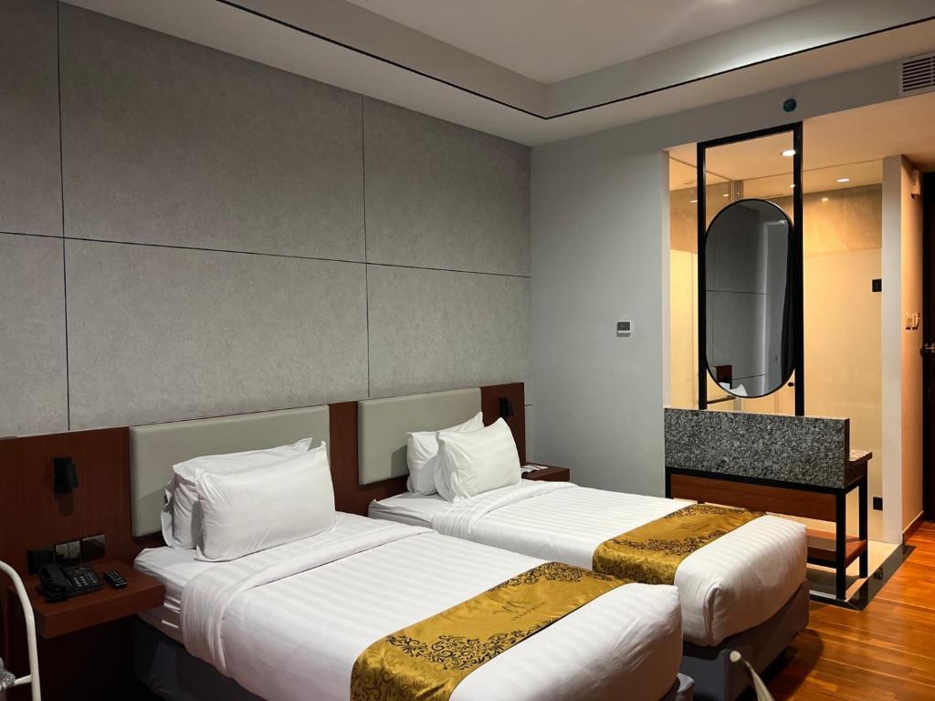 Postel nebo postele na pokoji v ubytování Grand Miami Hotel