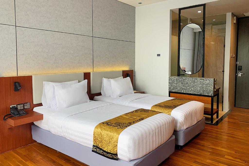 Postel nebo postele na pokoji v ubytování Grand Miami Hotel