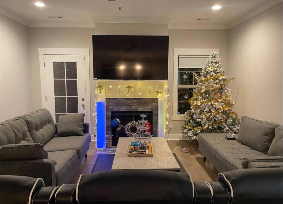 a living room with a christmas tree and a fireplace at Entire house 4Bedroom with 4Bath perfect for family in Murfreesboro