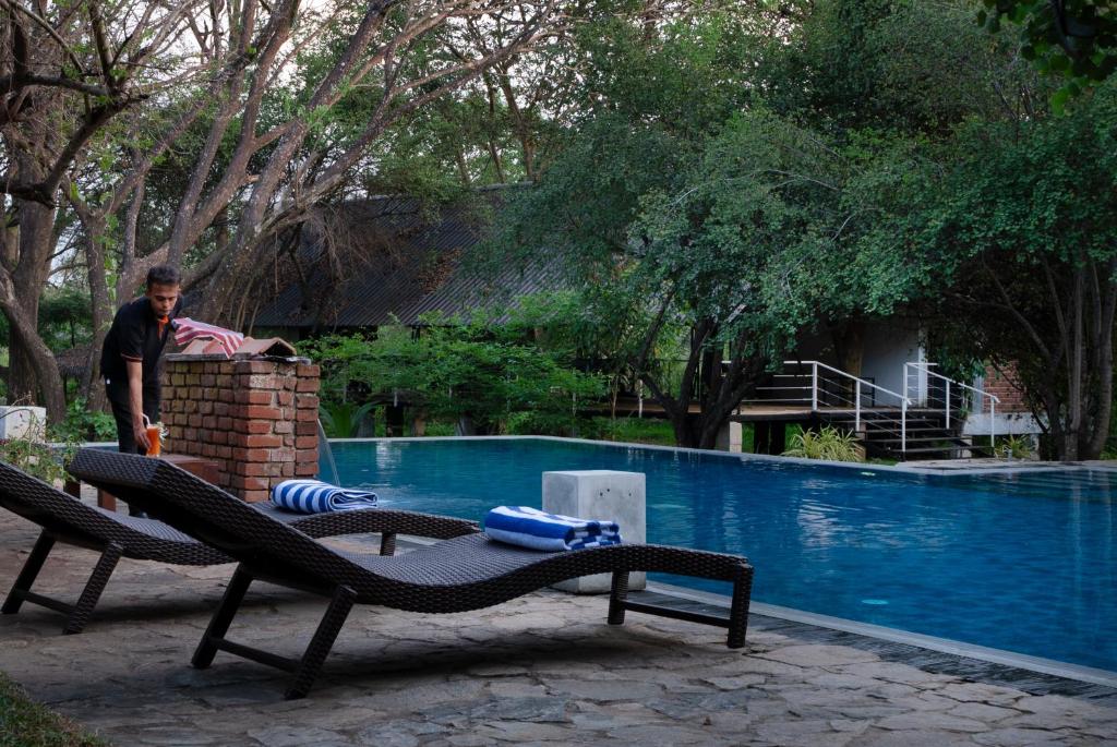 um homem ao lado de uma piscina em Lario Resort Sigiriya em Sigiriya