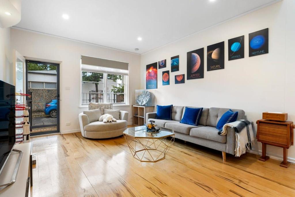 a living room with a couch and a table at Lego-Aerospace Free Parking CBD Chinatown in Adelaide