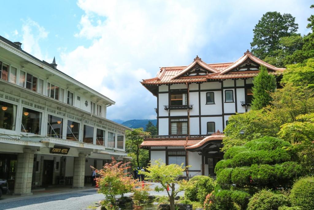 a building in a town with a mountain in the background at Nikko Kanaya Hotel in Nikko