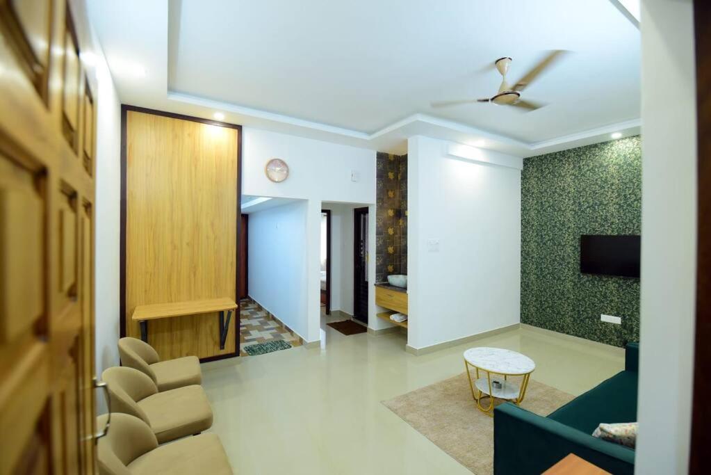 a living room with a couch and a table at Lourels Stay in Udupi