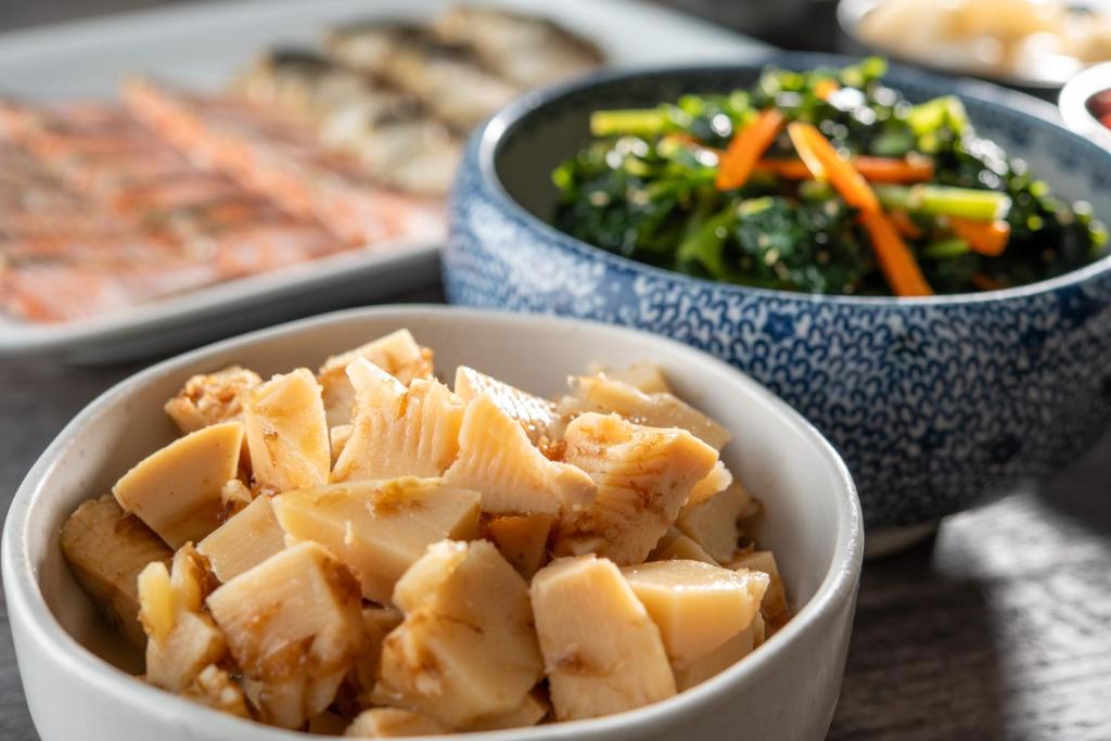 a bowl of food and a bowl of vegetables at HOTEL MYSTAYS PREMIER Omori in Tokyo
