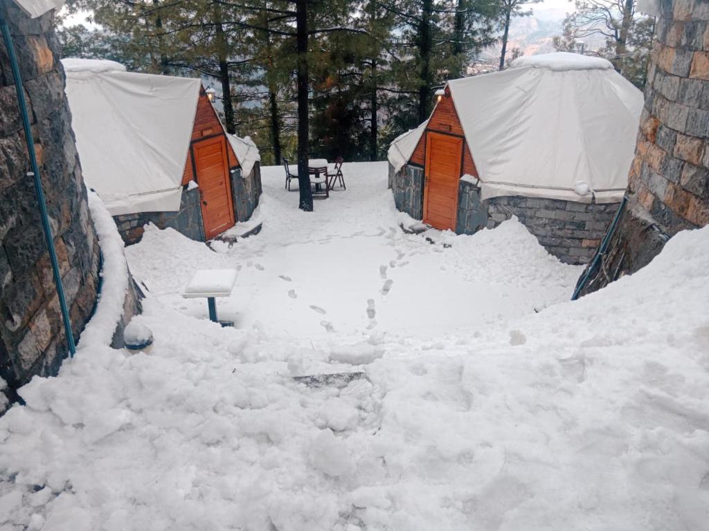 a group of tents covered in snow at Orange Loft, Glamp Park Murree in Murree