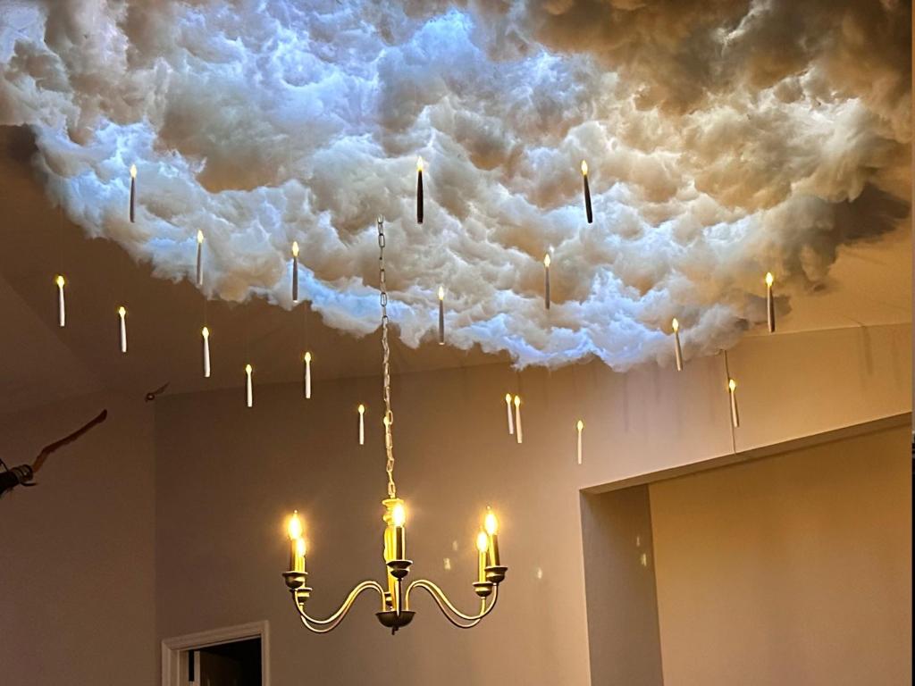 a chandelier hanging from a ceiling with clouds at Harry Potter Themed Luxury Apartment 3bd 2bth - Universal Studios in Orlando