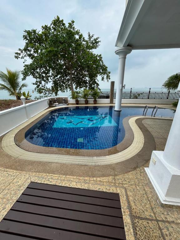 a swimming pool in the middle of a house at Luxery Villa Sea Side in Port Dickson