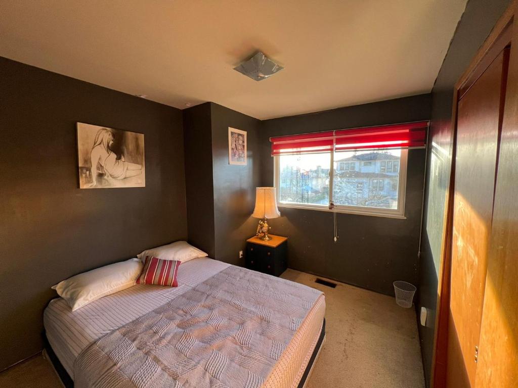a small bedroom with a bed and a window at Private Cozy Queen Room in North Delta in Delta