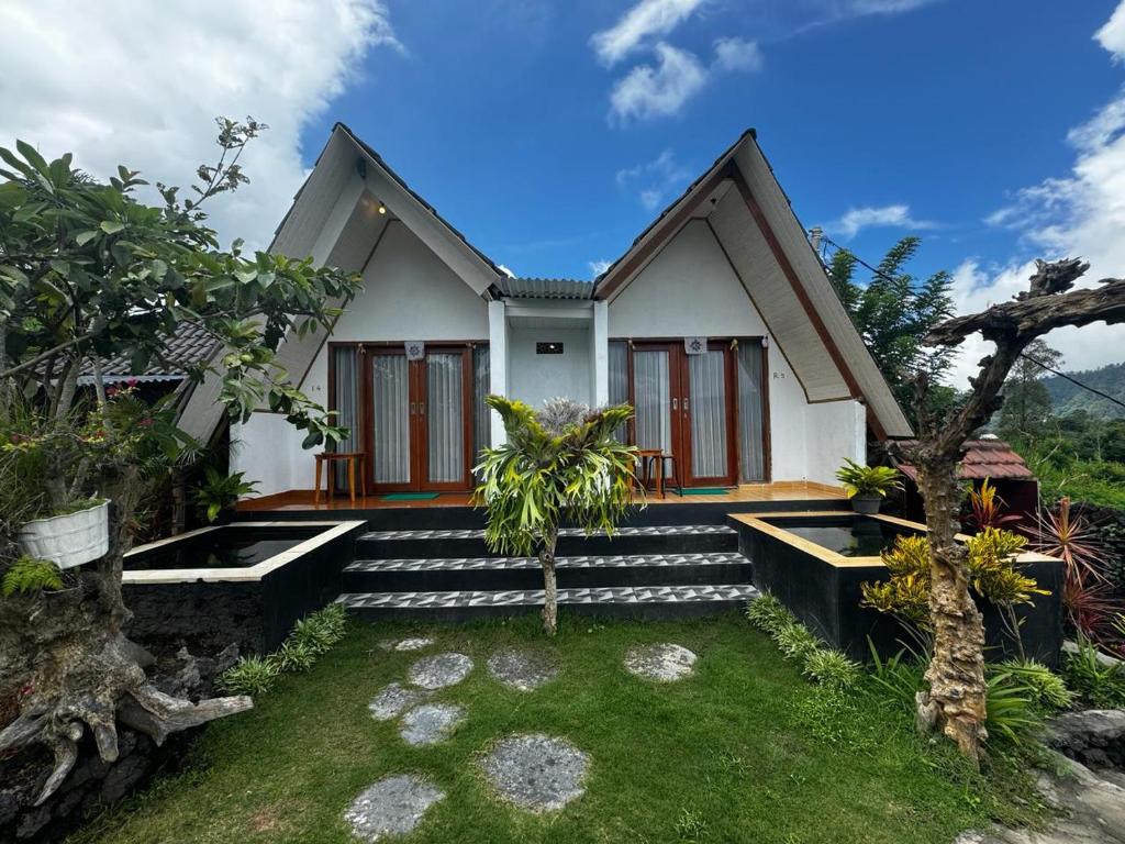a house with steps leading up to it at Belvilla 93878 Private Room In Kintamani Near Toya Devasya in Kintamani
