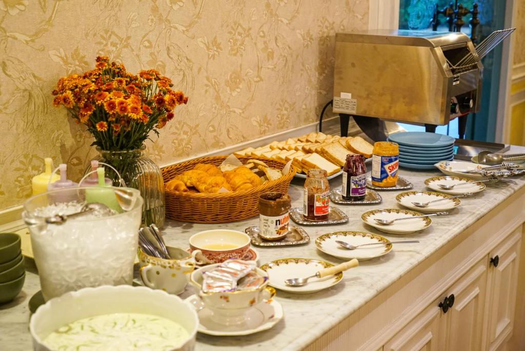 A breakfast counter offers bread, pastries, spreads, dairy items, and beverages.