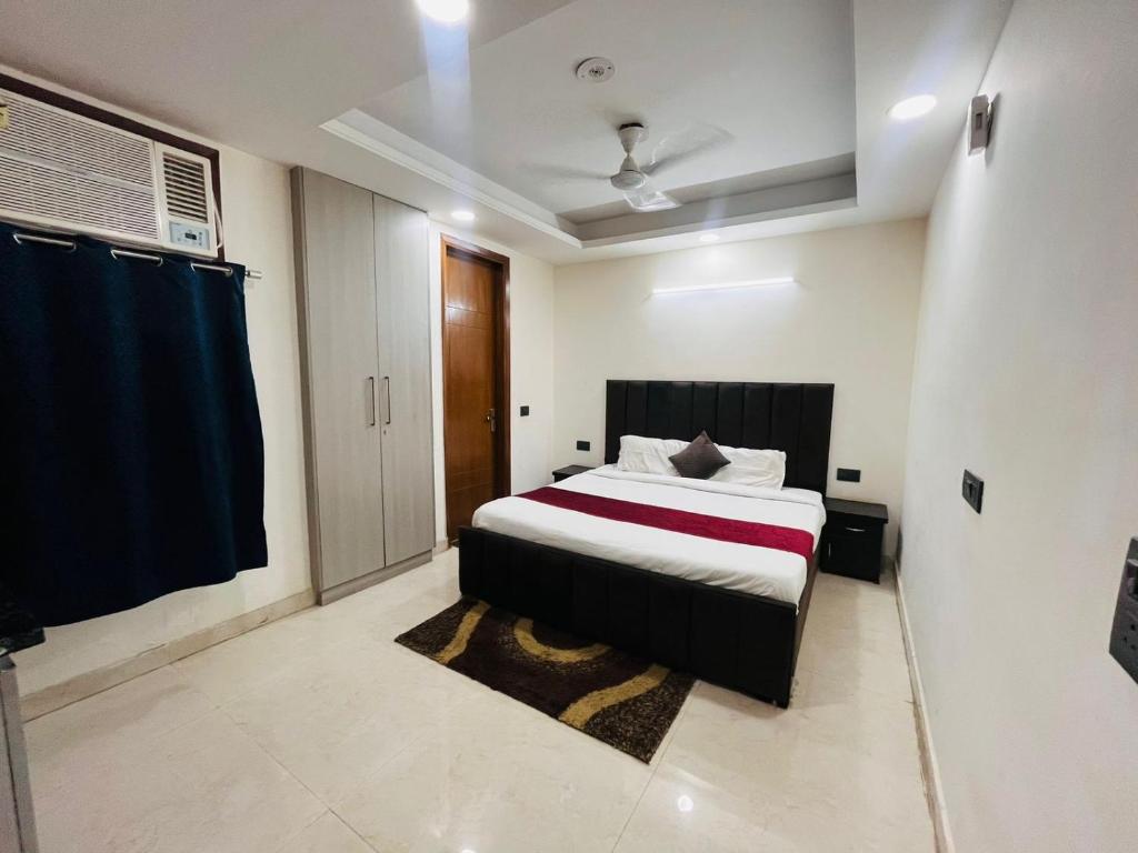 a bedroom with a bed in a room with a window at Hotel Saket Place - Near Saket Metro in New Delhi
