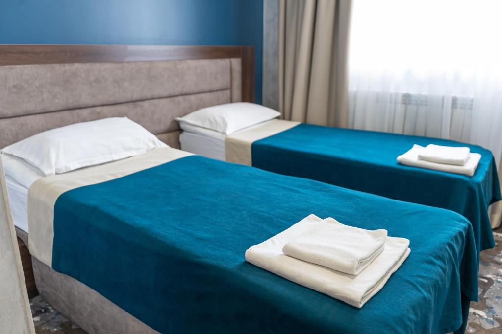 Postel nebo postele na pokoji v ubytování MILDOM Express