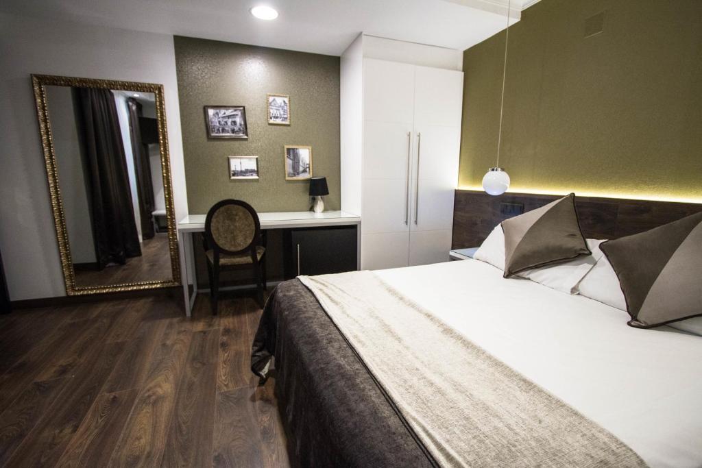 a bedroom with a bed, desk, and chair at Moderno in Barcelona