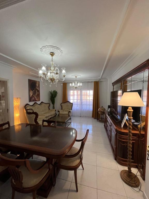 a living room with a dining room table and a television at Retro Vintage Toscal Bus stop 5p in Los Realejos