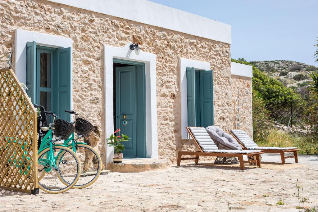 a bike parked in front of a building with blue doors at Lady Stamatias House in Halki