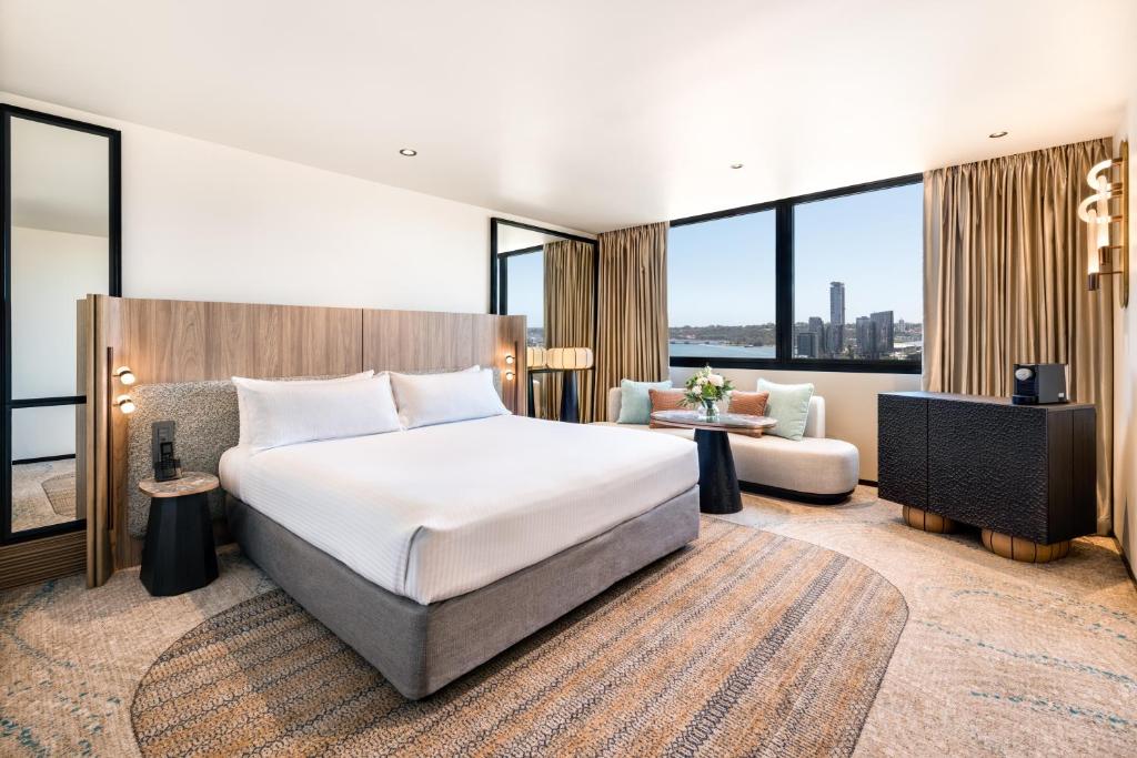 a hotel room with a bed and a couch at Pan Pacific Perth in Perth