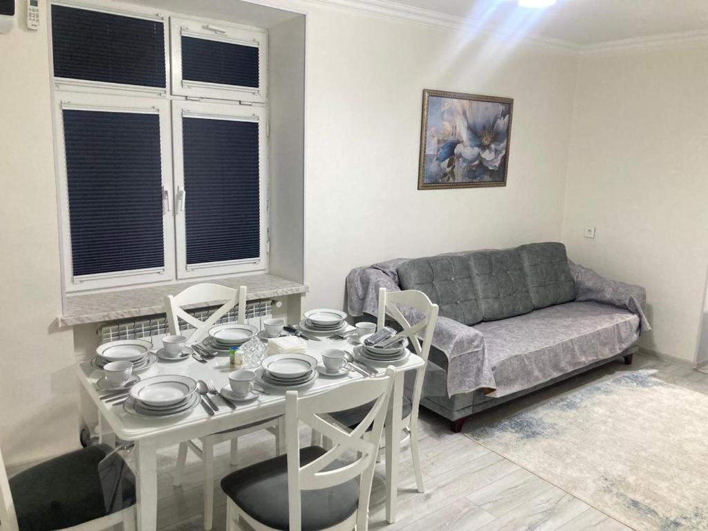 a living room with a table and a couch at AZERBAYCAN in Sumqayıt