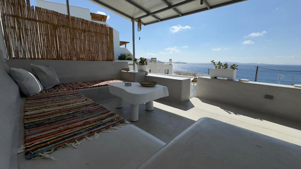 a balcony with a table and a view of the ocean at Mykonos Tourlos Nests - Sea View Escape in Tourlos