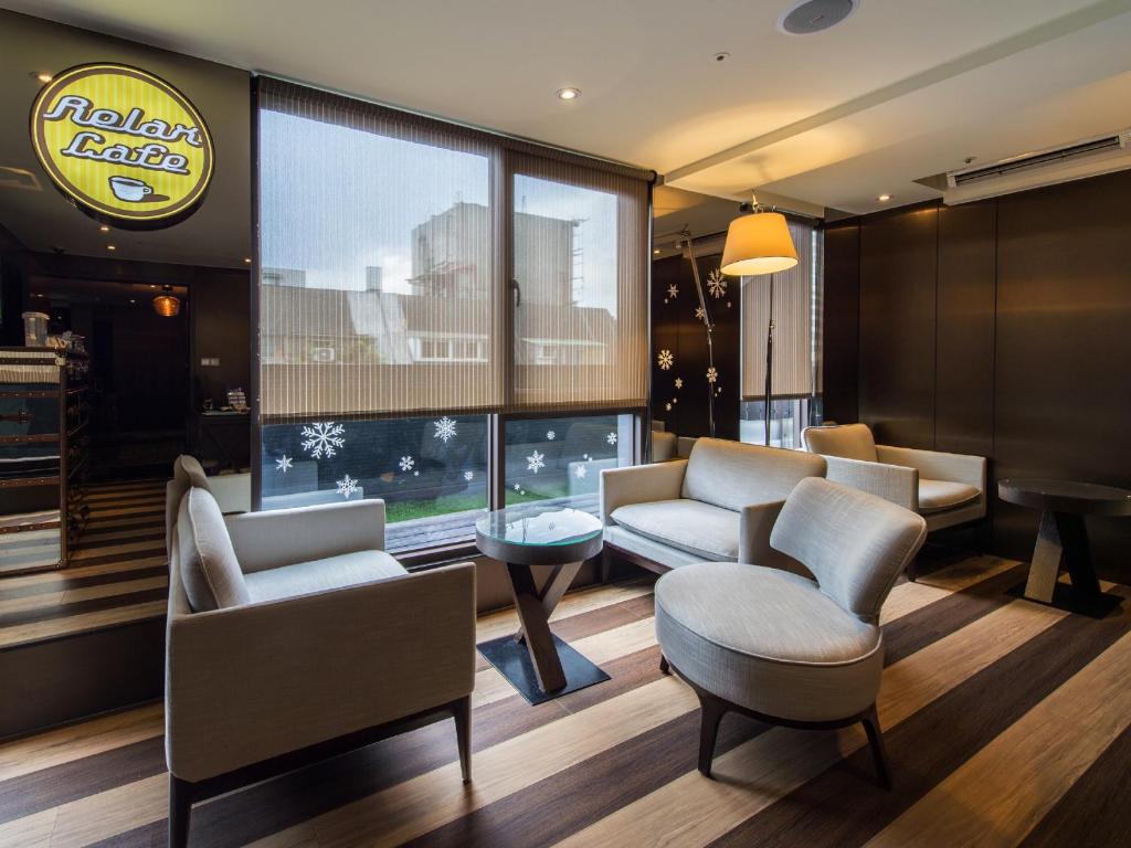 a waiting room with couches and chairs in a building at Hotel Relax I in Taipei