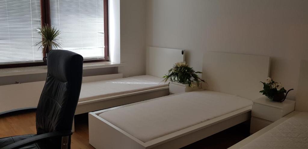 um quarto branco com um banco e uma janela em Apartment Hannover-Hemmingen em Hemmingen