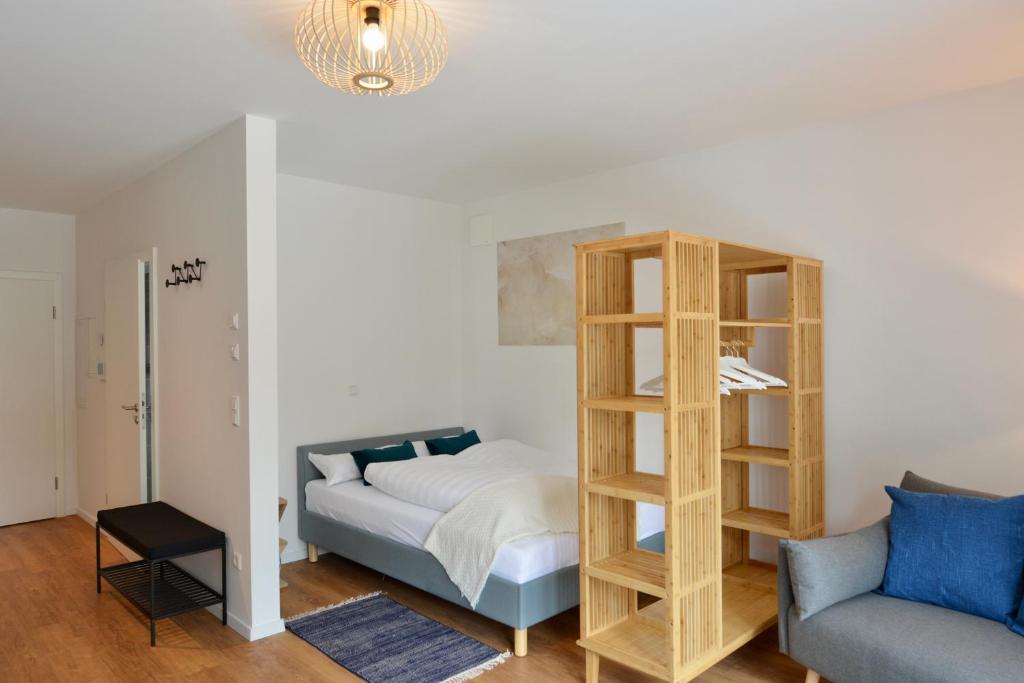 a bedroom with a bed and a book shelf at Business Living Oberkochen in Oberkochen