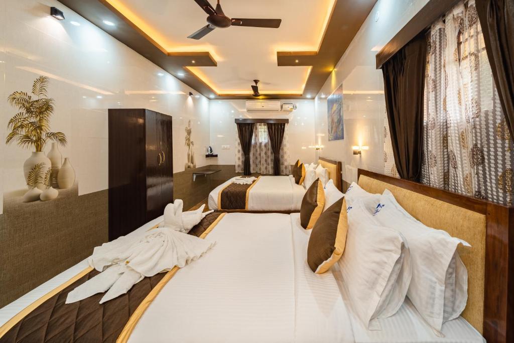a large bedroom with two beds and a ceiling at Mayas Beach Farm House in Pūrnānkuppam