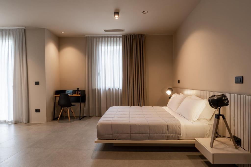 Un dormitorio con una cama y una cámara en un trípode en Amare Suite & Apartments, en Bellaria-Igea Marina