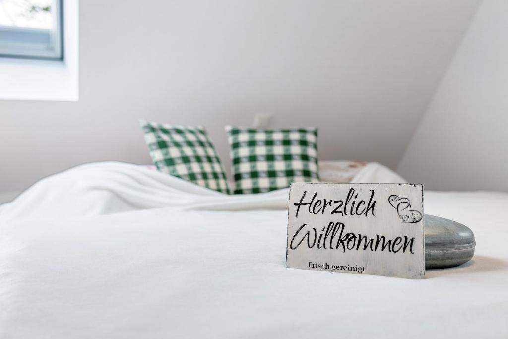 a sign sitting on top of a bed at Stub'n Ludwig in Waischenfeld