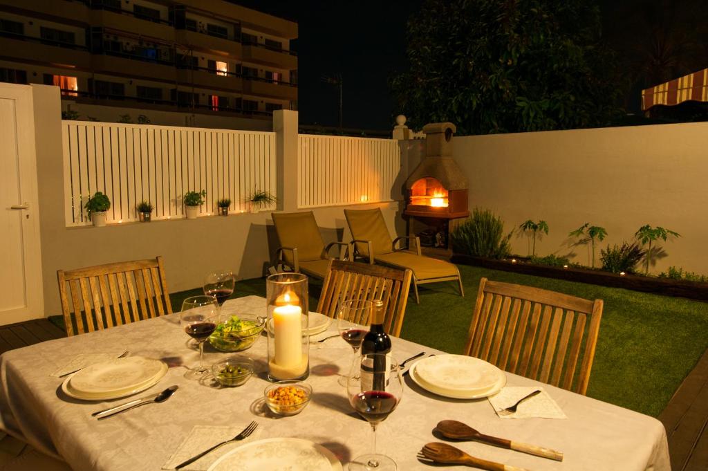 una mesa con platos de comida y una vela en ella en BN04 Central Playa del Ingles by VillaGranCanaria, en Playa del Inglés