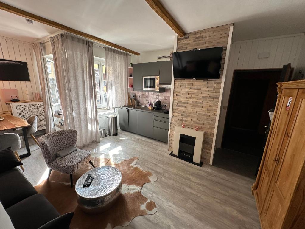 a living room with a couch and a fireplace at Appartamento Kern-Sciare A Portata Di Mano- in Madesimo