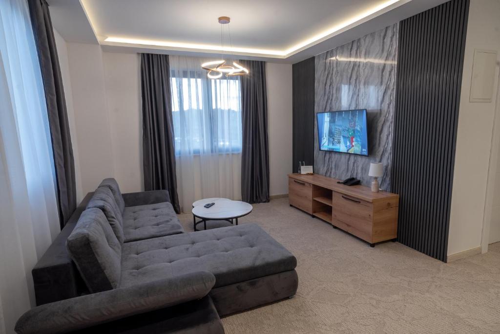a living room with a couch and a tv at Hotel Sistems in Banja Luka