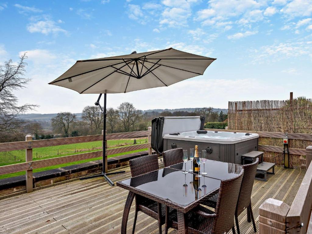 a patio with a table and an umbrella at 2 Bed in Apperknowle 94513 in Unstone