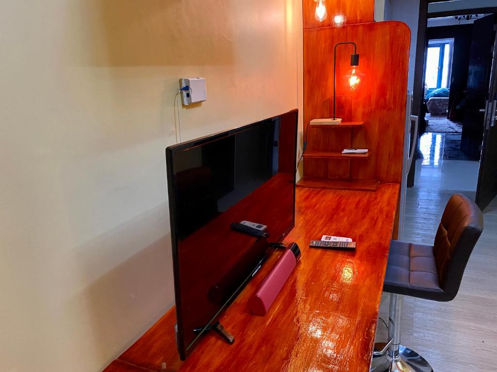 a flat screen tv sitting on top of a wooden table at Zen Japan Oasis Tokyo Tranquility Makati Condo Blazing Fast Internet 300 Mbps in Manila