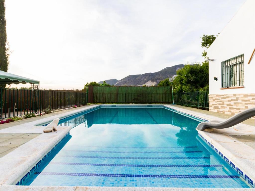 a swimming pool in the backyard of a house at Cortijo Valmaruc in Dúrcal
