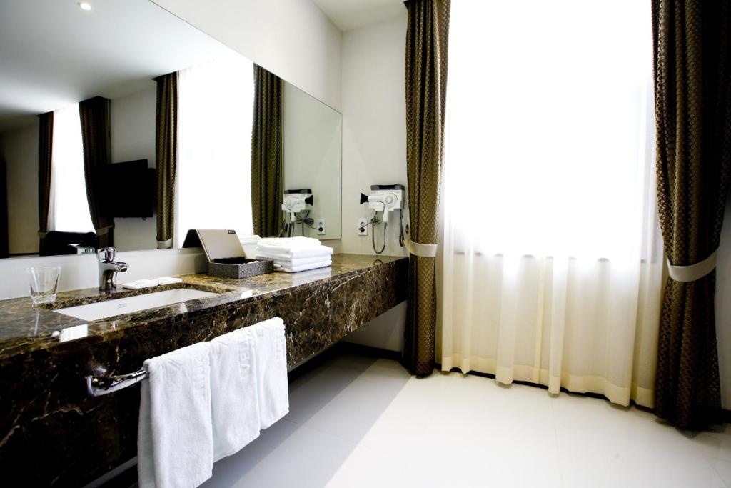 a bathroom with a sink and a mirror at Hotel Doma Myeongdong in Seoul