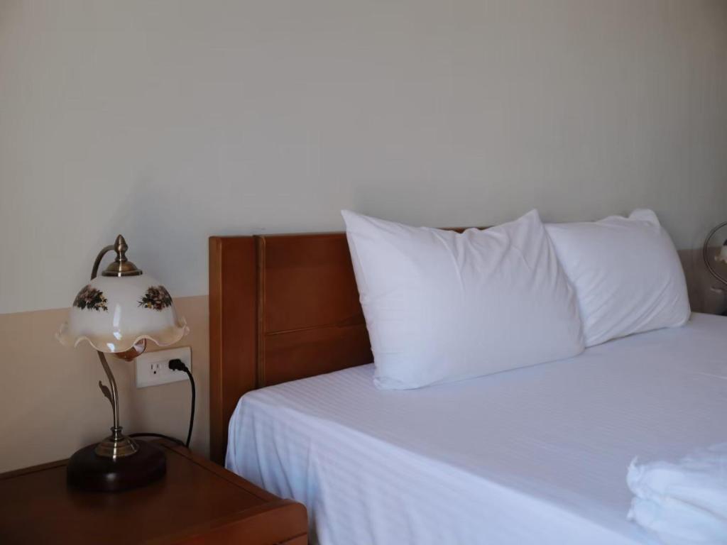 Postel nebo postele na pokoji v ubytování 九屏文旅 JP guesthouse