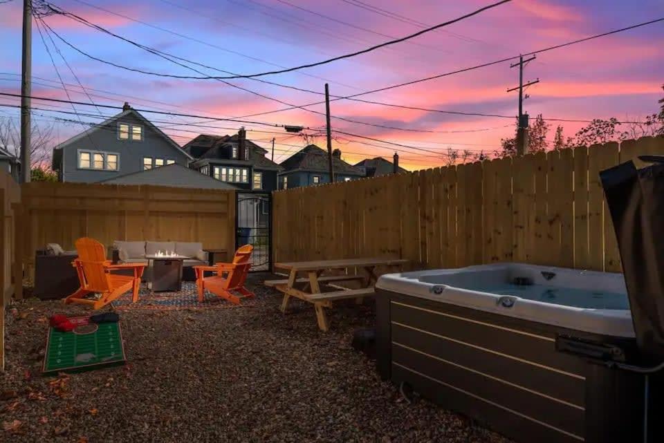 a backyard with a hot tub and a wooden fence at 5 Bedrooms Sleeps 14 - Hot Tub - 1 min to Fairgrounds in Columbus