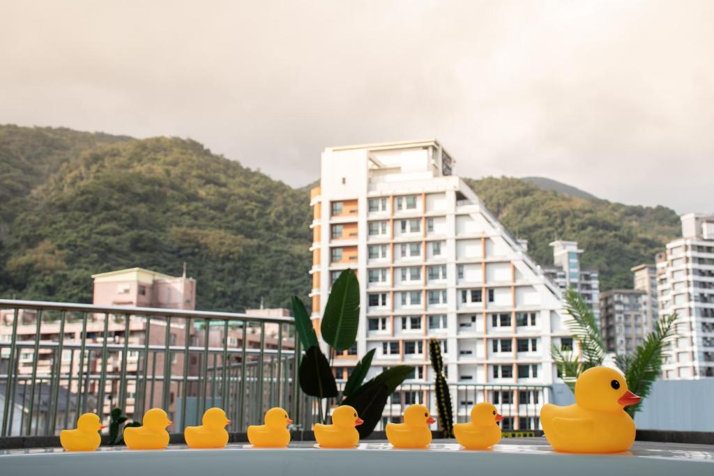 a group of rubber ducks sitting in front of a building at Ashare Hotel in Jiaoxi