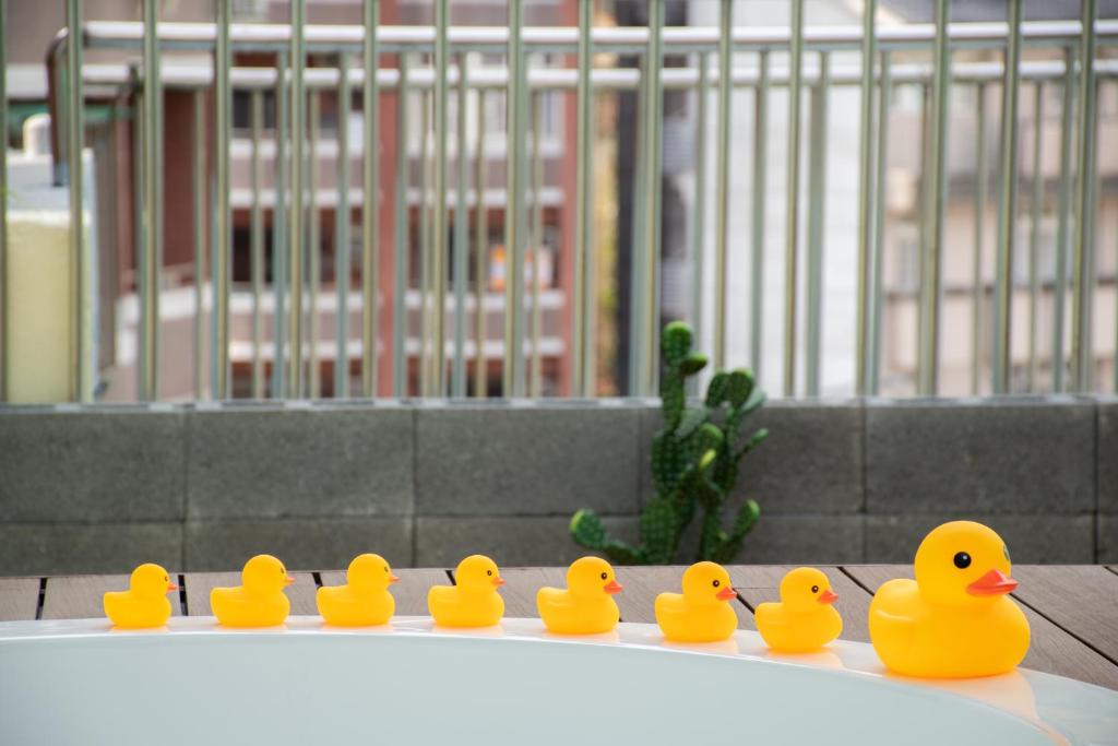 a group of rubber ducks sitting on a table at Ashare Hotel in Jiaoxi