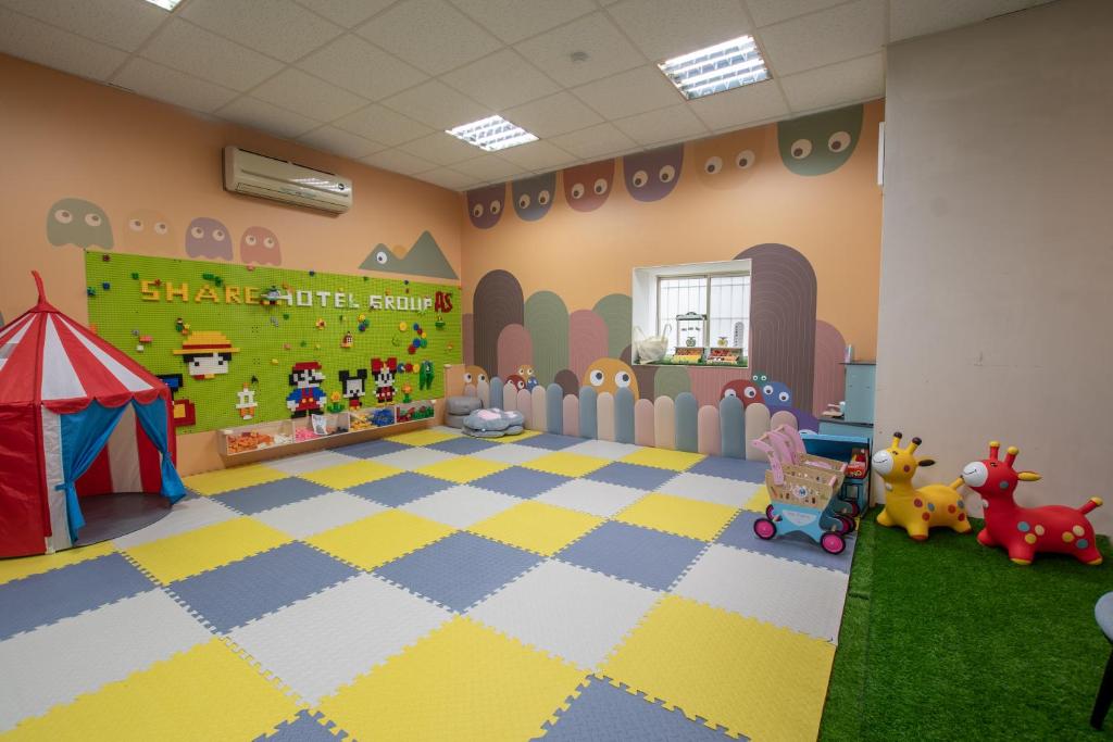 a room with a playroom with a tent and toys at Ashare Hotel in Jiaoxi