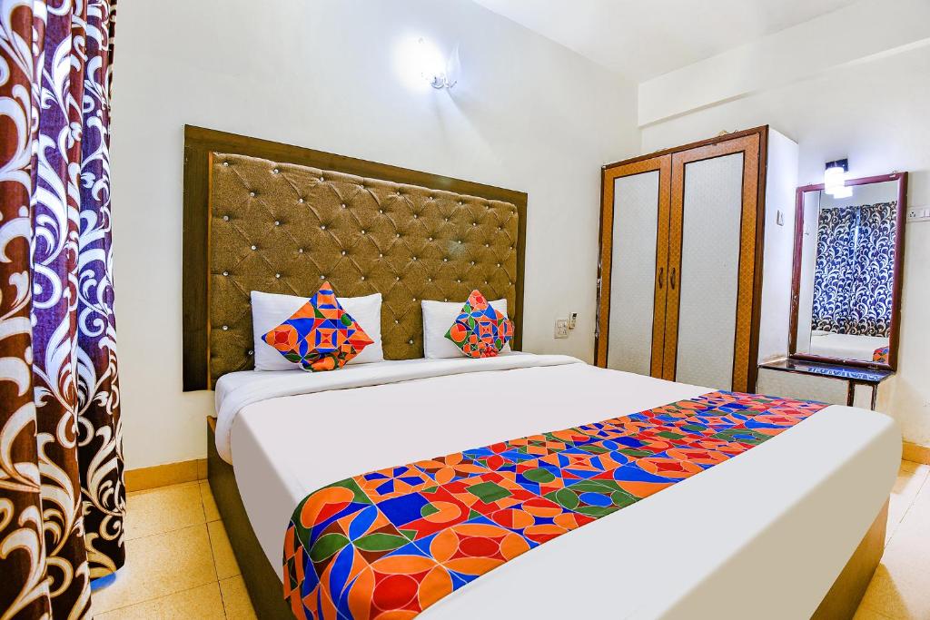 a bedroom with a large bed with a colorful blanket at Via Jesant Valley Resort - Nr Candolim Beach in Candolim