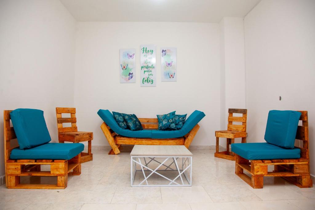 a room with two blue chairs and a table at Casa fresca y amplia de 4 habitaciones in Cali