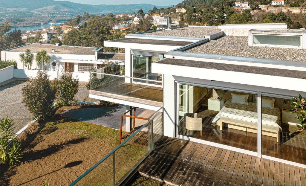 a house with a balcony with a view of a city at Casa do Alto da Barrosena - Cerveira in Vila Nova de Cerveira