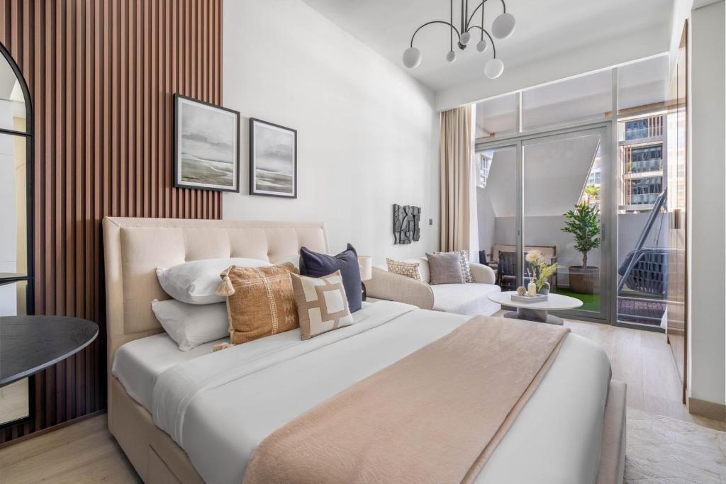 a bedroom with a large bed and a living room at GuestReady - Urban Retreat in Downtown in Dubai