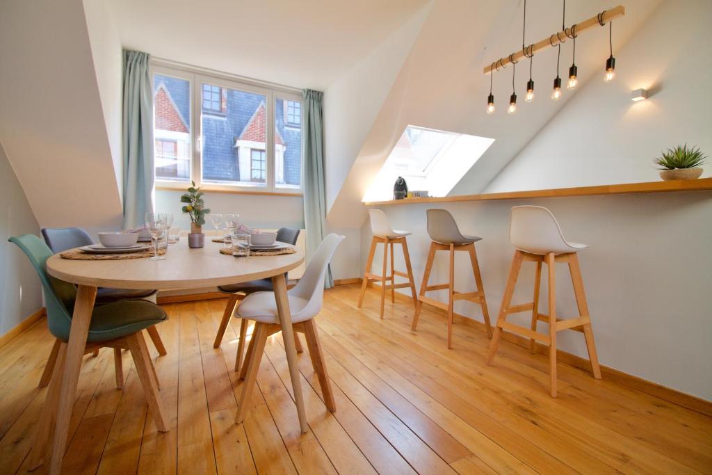 a dining room with a table and chairs at Heart of Grand Place - Stunning 2BR Duplex in Brussels