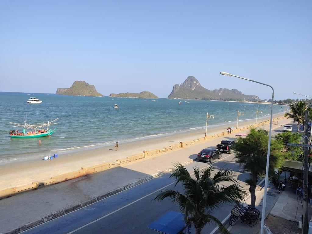 a view of a beach with a boat in the water at Darin's Place in Prachuap Khiri Khan