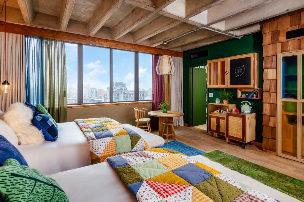 a living room with two beds and a window at Treehouse Hotel Manchester in Manchester