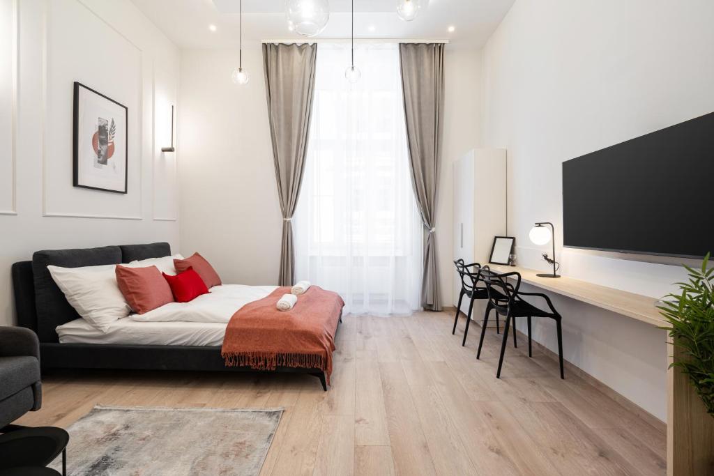 a living room with a couch and a flat screen tv at D20 - Gozsdu Garden Residence - Best Location by BQA in Budapest